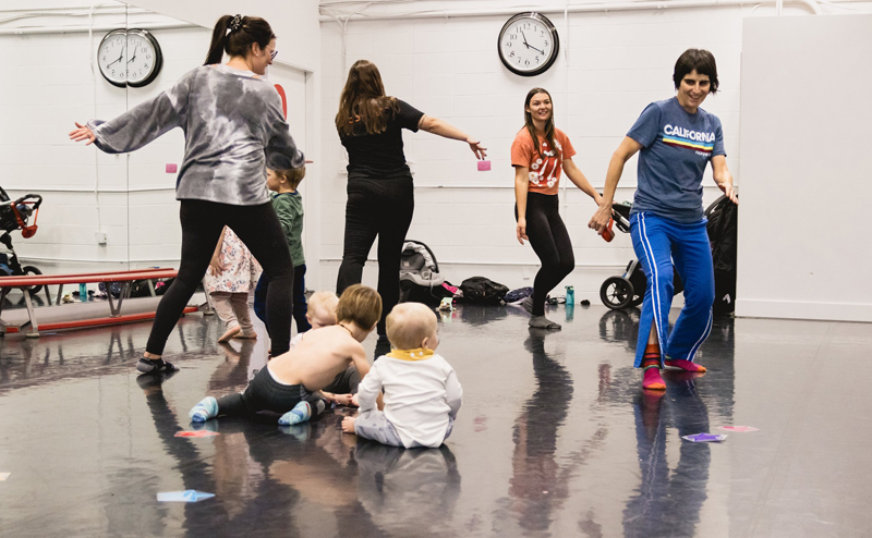 Grown ups and young children dancing.