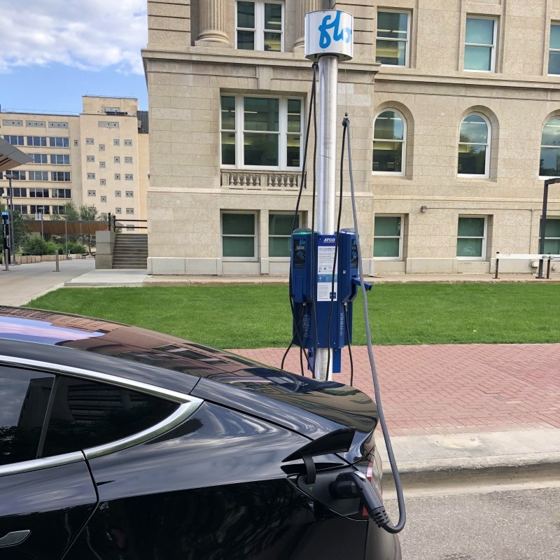 Electric vehicle plugged into a street charger