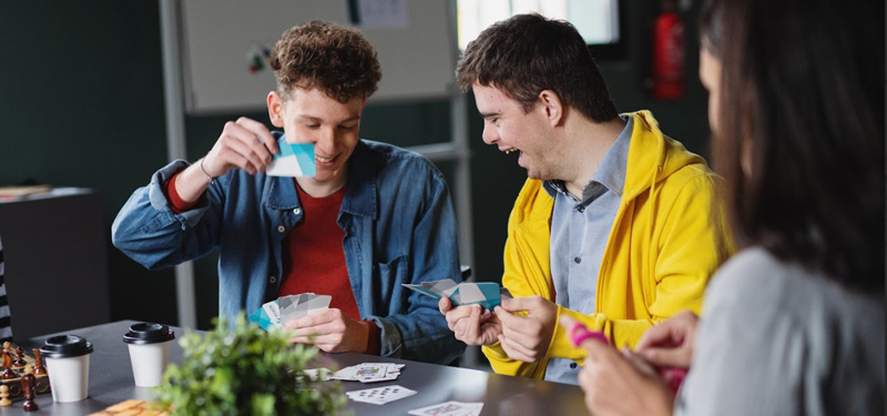 People with disabilities playing cards.