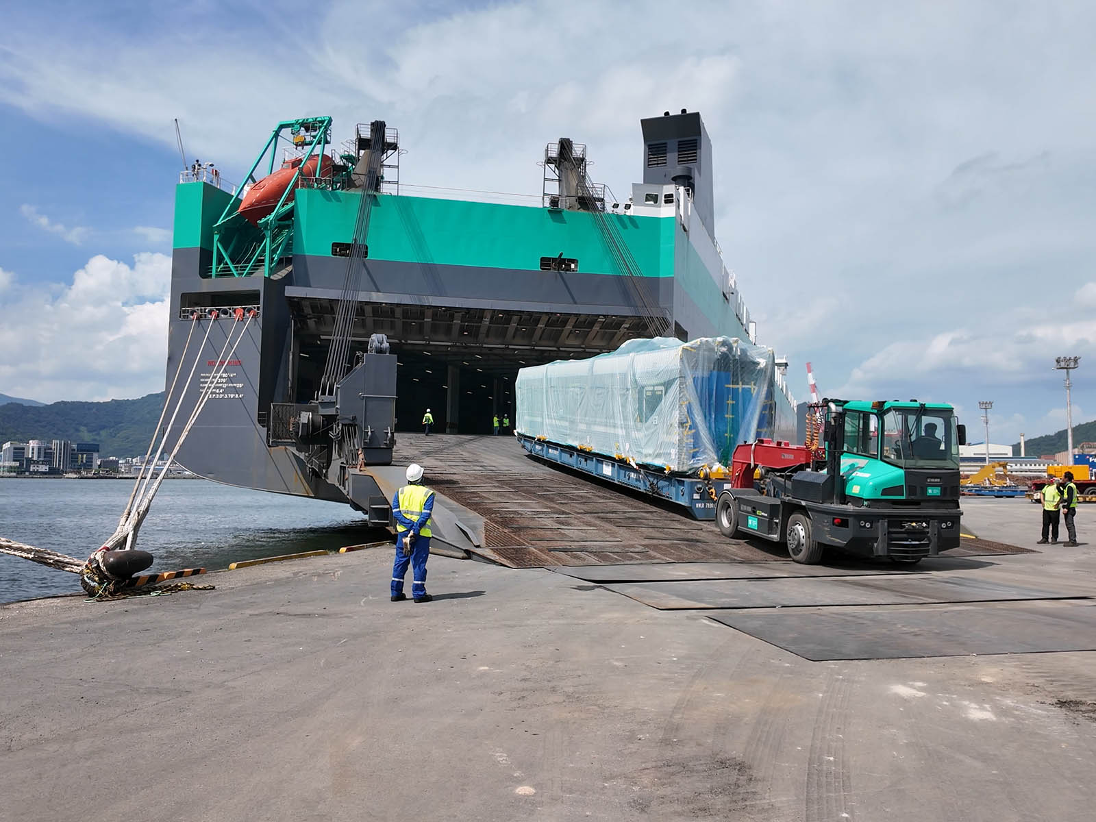 The first Valley Line West Light Rail Vehicle being loaded on a cargo ship in south Korea