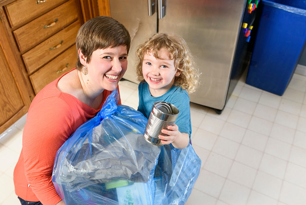 woman with child holding recycle bags