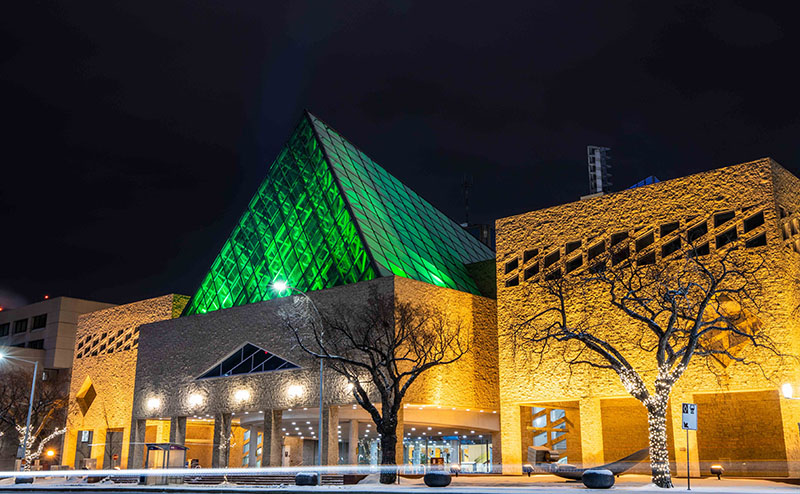 City Hall building lit up at night in winter