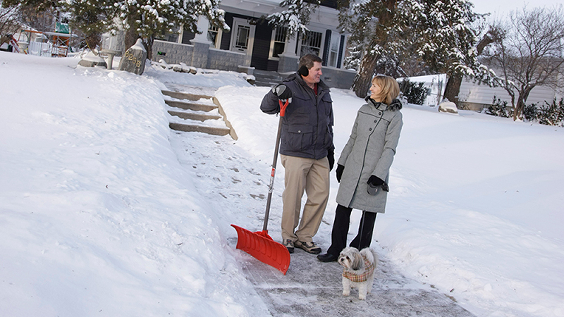 Neighbours shoveling their walks in winter