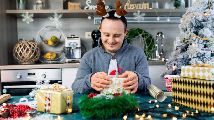 a man wrapping a holiday present