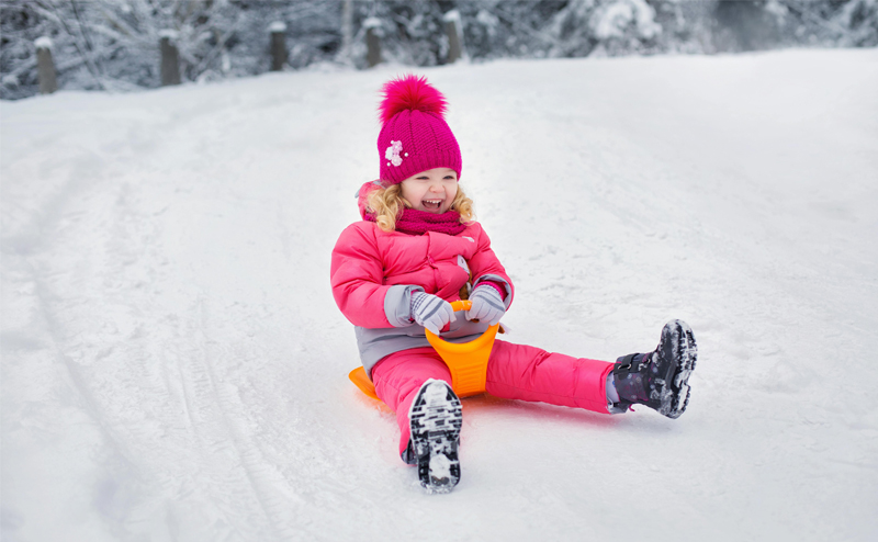 A child on a toboggan hill.