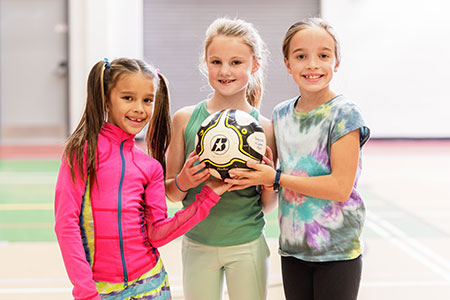 girls holding ball