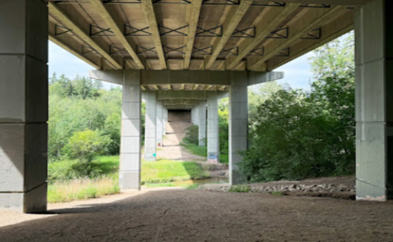 View of the underside of the Millcreek Pedestrian Bridge with pillars visible