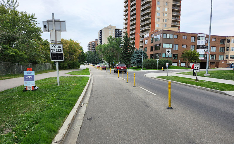 divided road with summer street sign