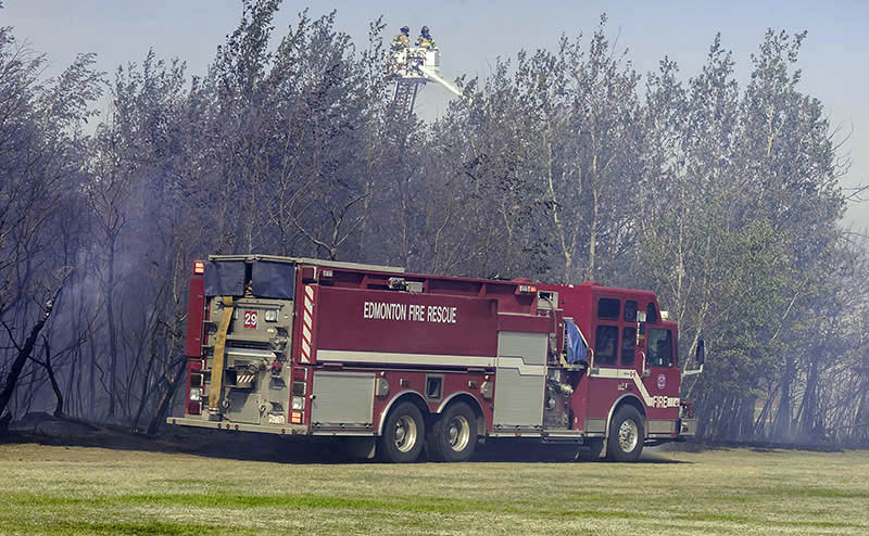 An Edmonton Fire Rescue crew working to extinguish a wildfire