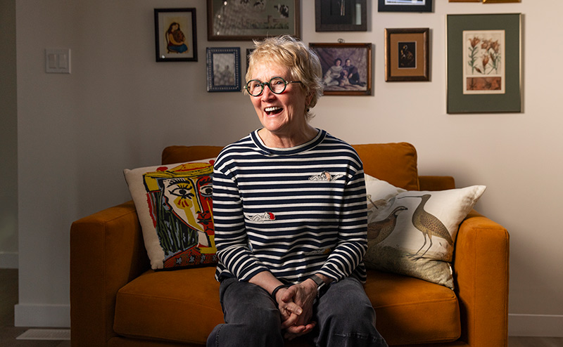 Older adult sitting smiling in sofa