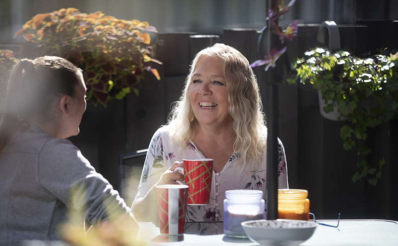 two persons sitting at table having food together