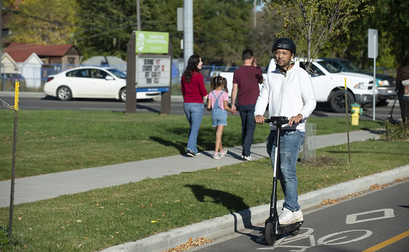 Man riding e-scooter in bike lane