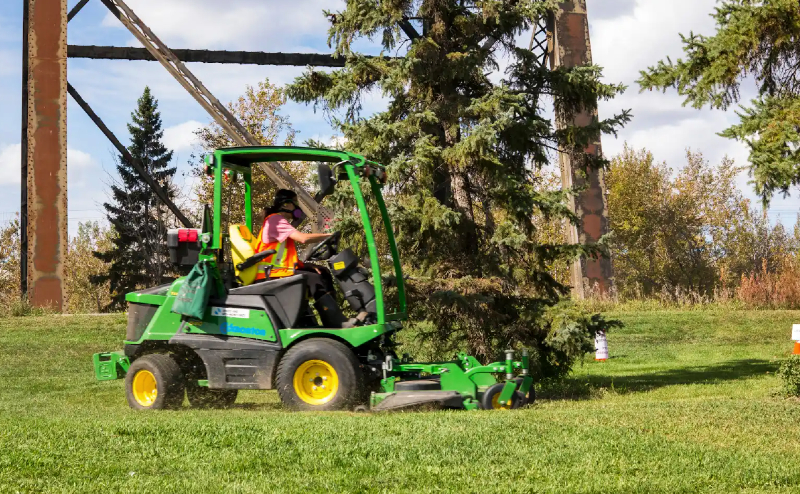 Person cutting grass on ride-on lawnmower