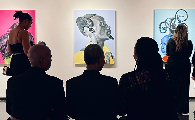 3 women looking at art