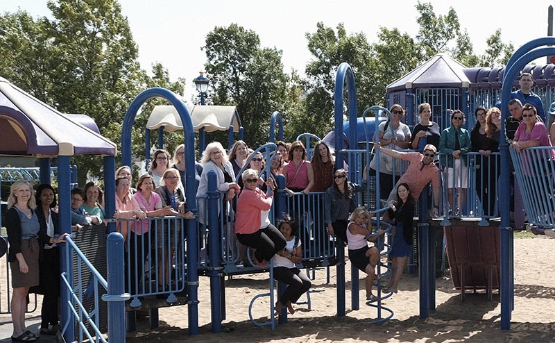 community members on playground equipment