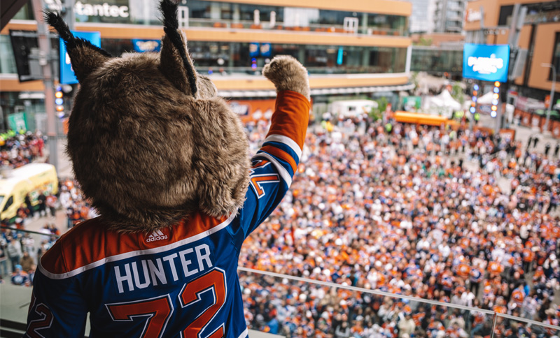 Hunter mascot cheering in front of crowd