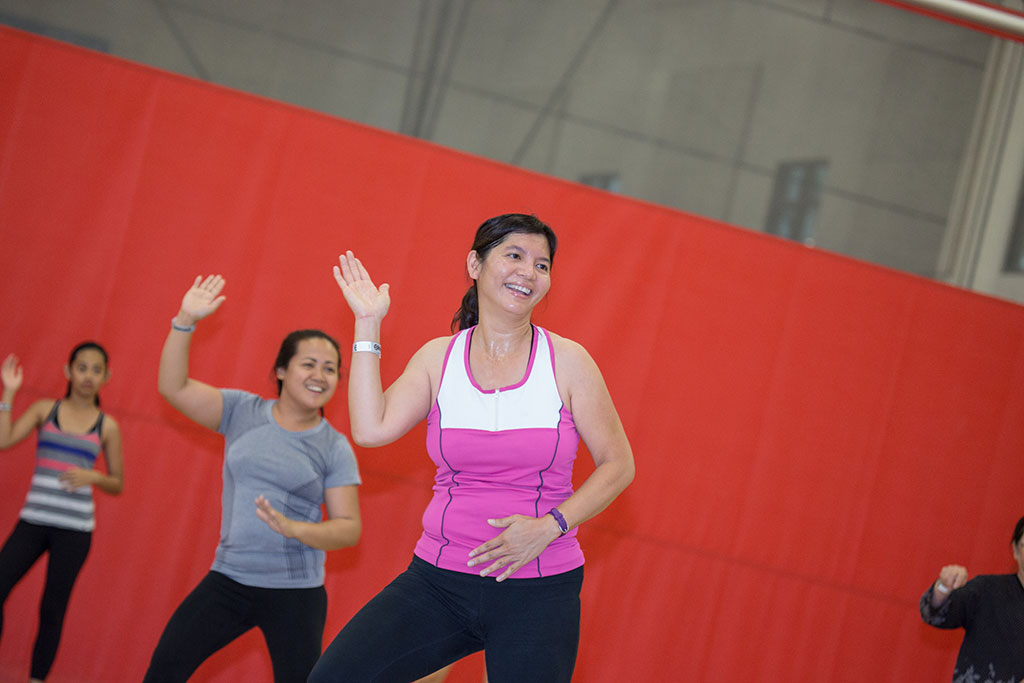 A group of women in a gymnasium during a fitness class.