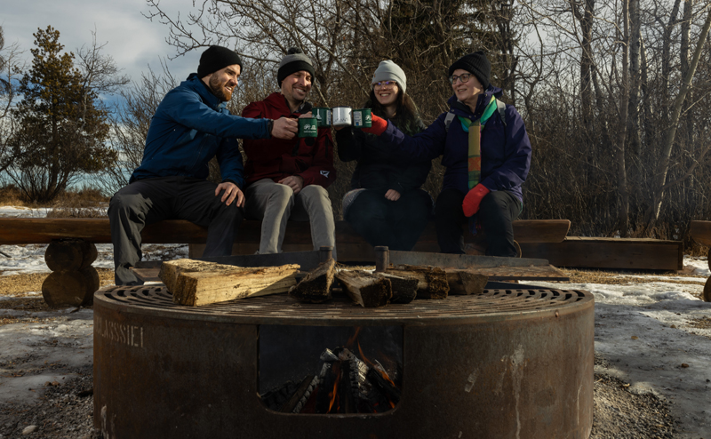 People outdoors around a campfire in winter