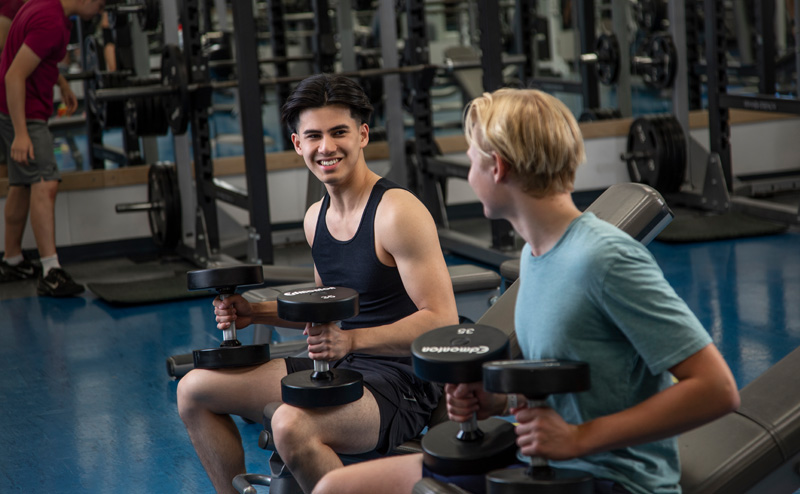 two boys holding weights