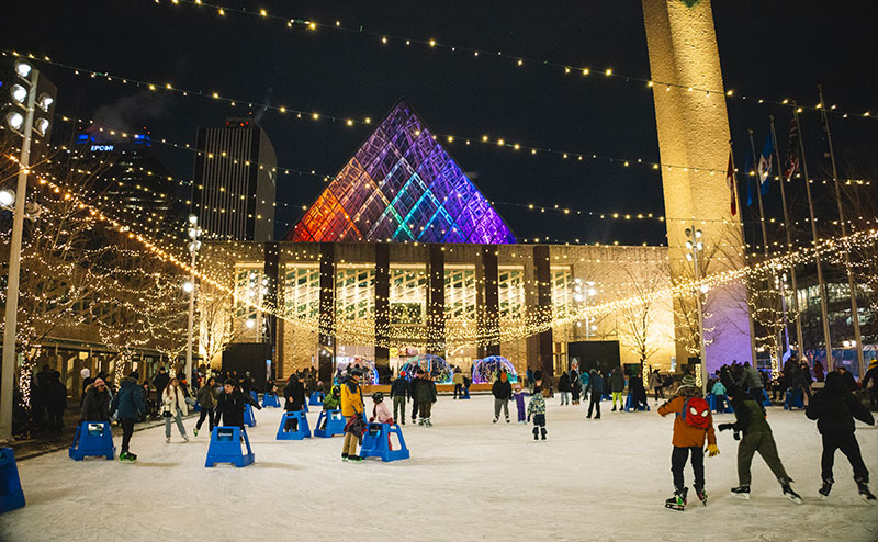 many people skating while surrounded by lights