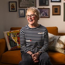senior person on sofa laughing