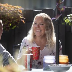person in backyard talking to friend