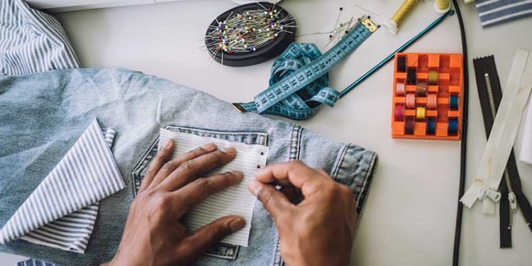 people sewing used pants