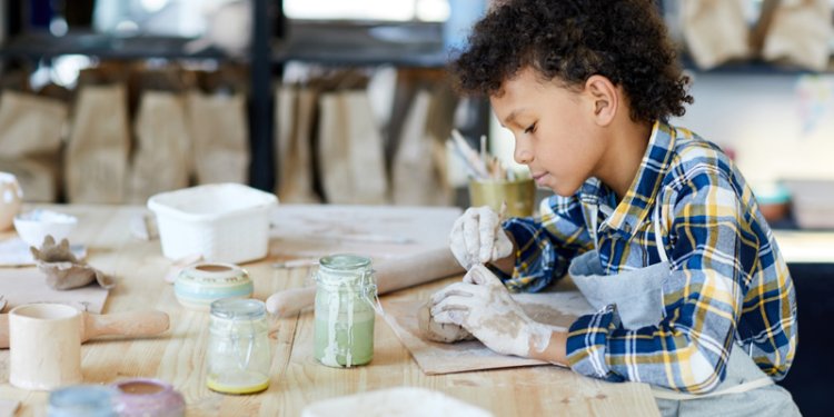 kid working with clay
