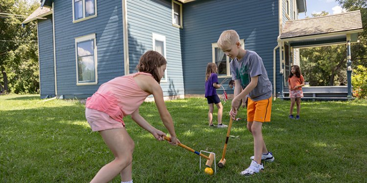 kids playing croquet on lawn