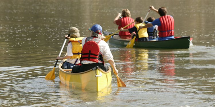 persons in canoe on river