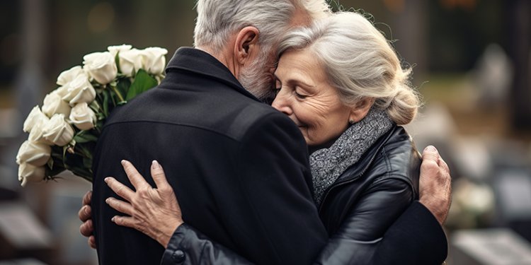couple hugging each other. Lady holding bunch of white roses