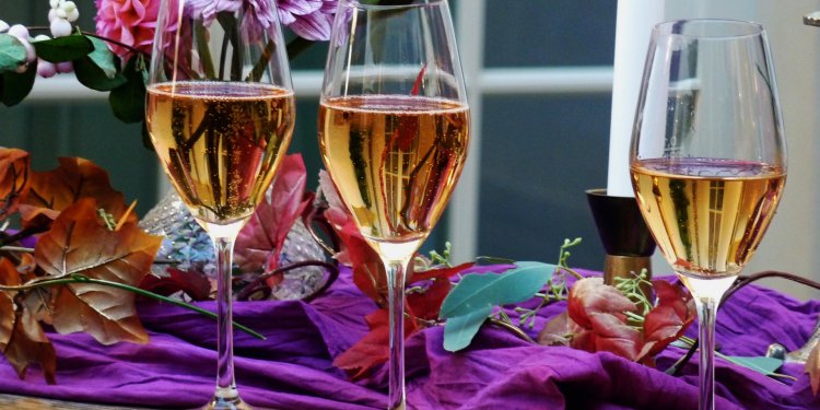 wine glasses on table with flowers
