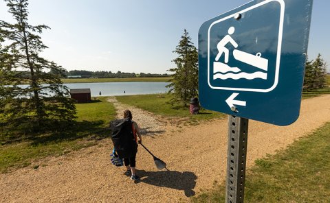 person carrying boat and oar
