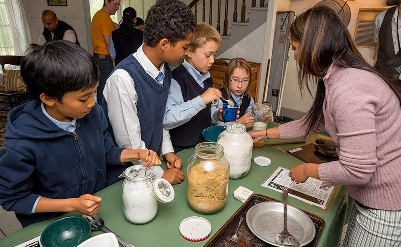 kids and instructor at table with baking tools