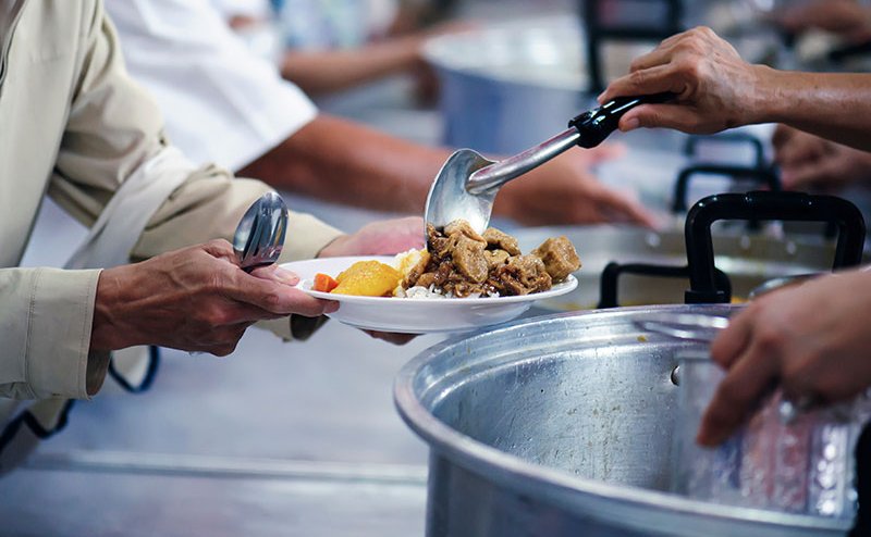 person being given a plate of food