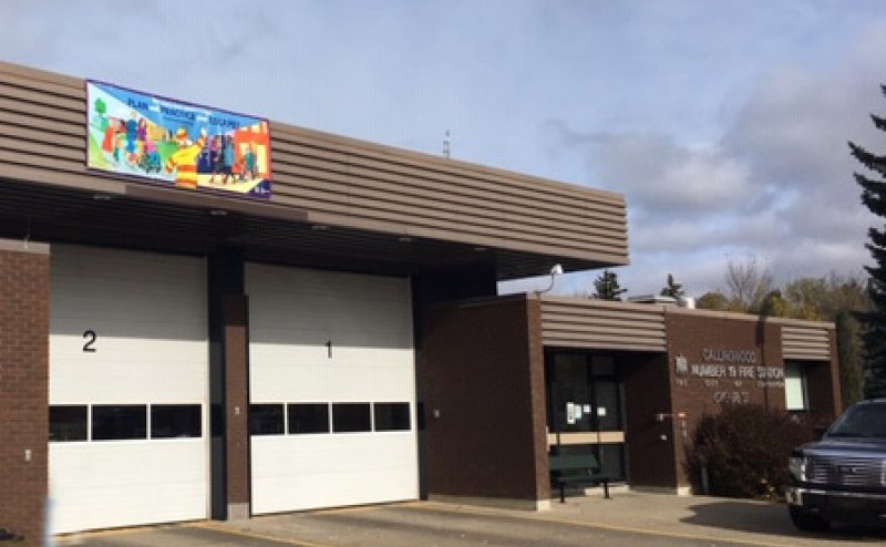 brown building with two white garage doors