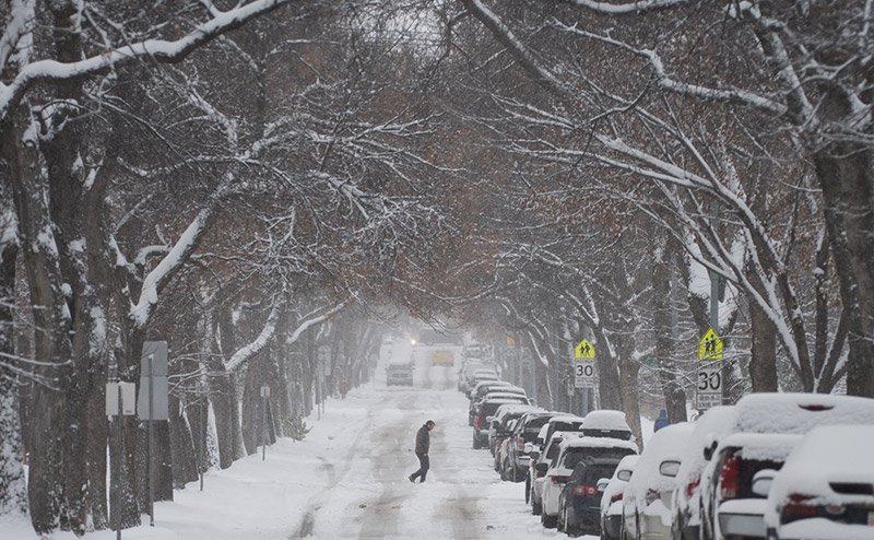 person walking in snow on streets