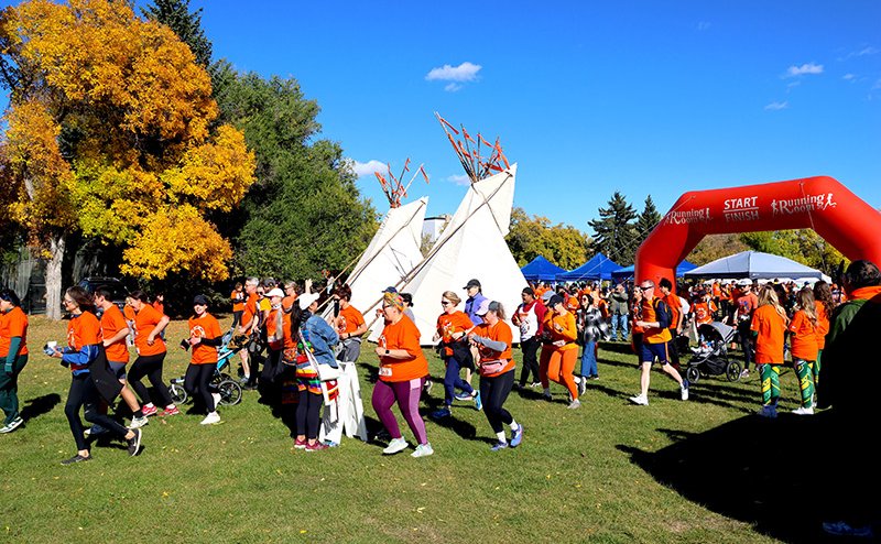 persons holding hands at event