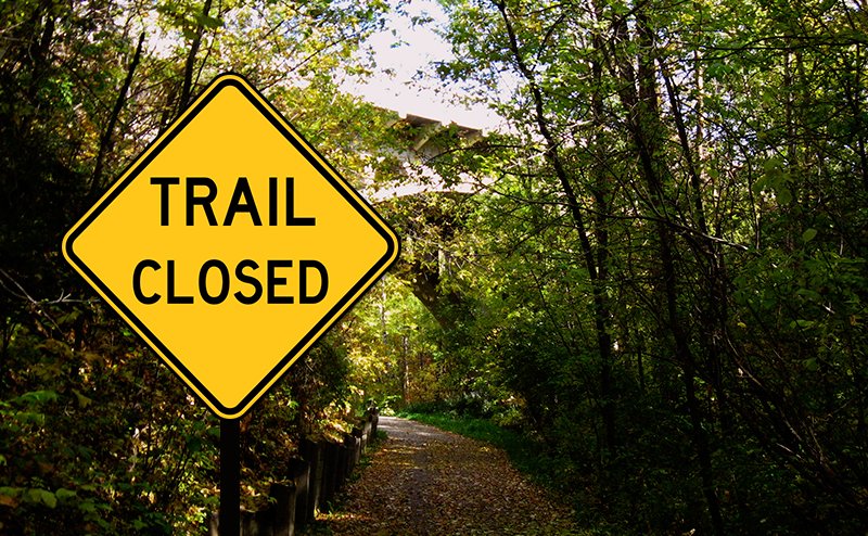 sign saying trail closed