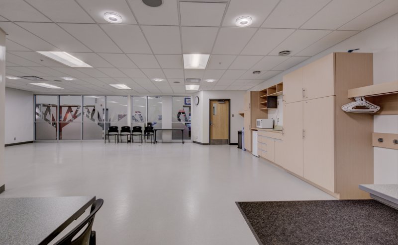 room with kitchenette and tables