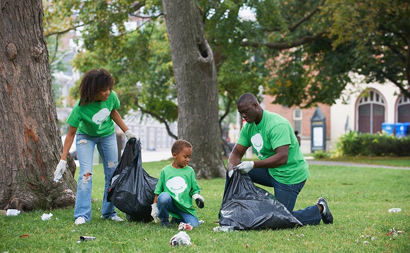 family picking up litter