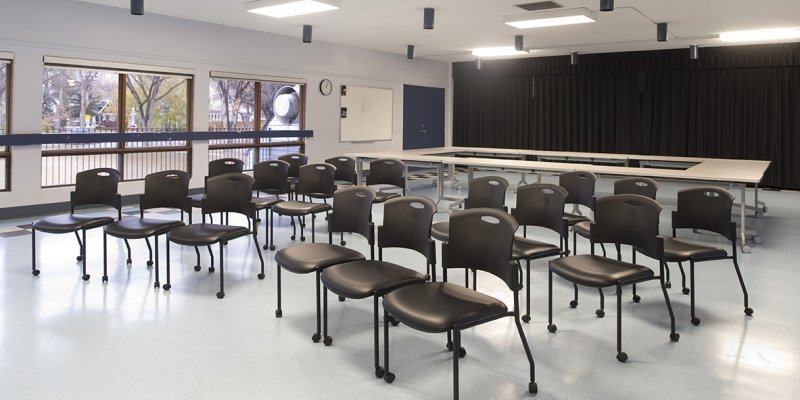 drama room with chairs, black curtain at back of room