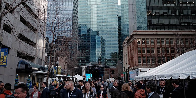 Delegates to the 2023 Canadian Hydrogen Convention enjoy a street part in downtown Edmonton