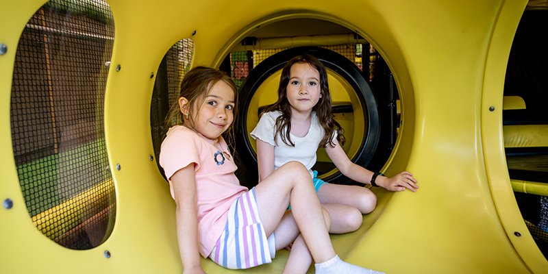 two kids in play structure