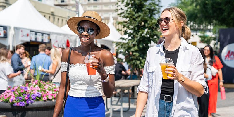 Two people enjoy some refreshing beverages at Taste of Edmonton in the downtown