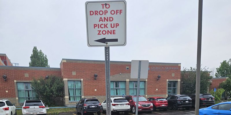 Drop off and pick up sign in a school zone